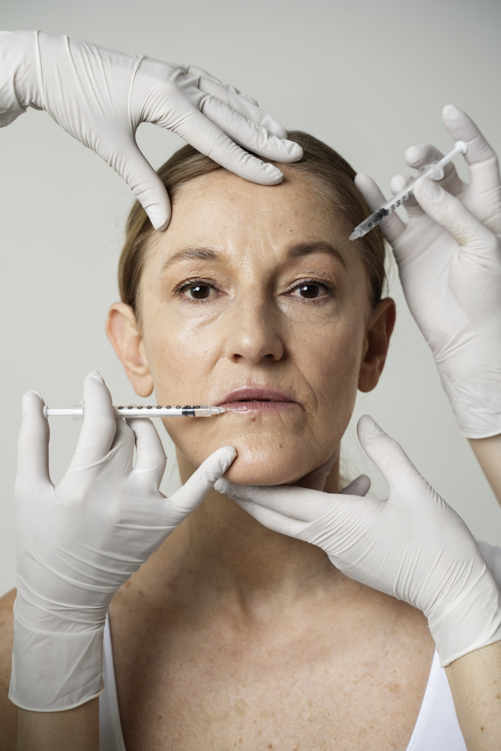 front view senior woman getting facial injections scaled